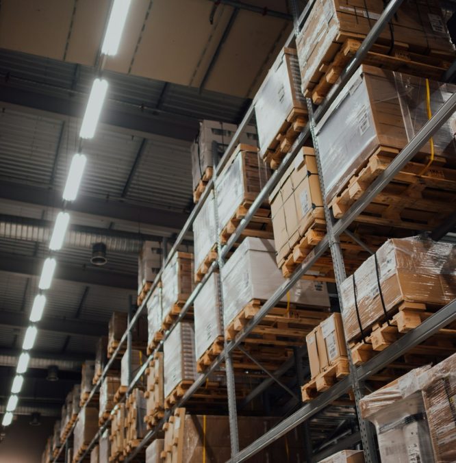 brown cardboard boxes on white metal rack